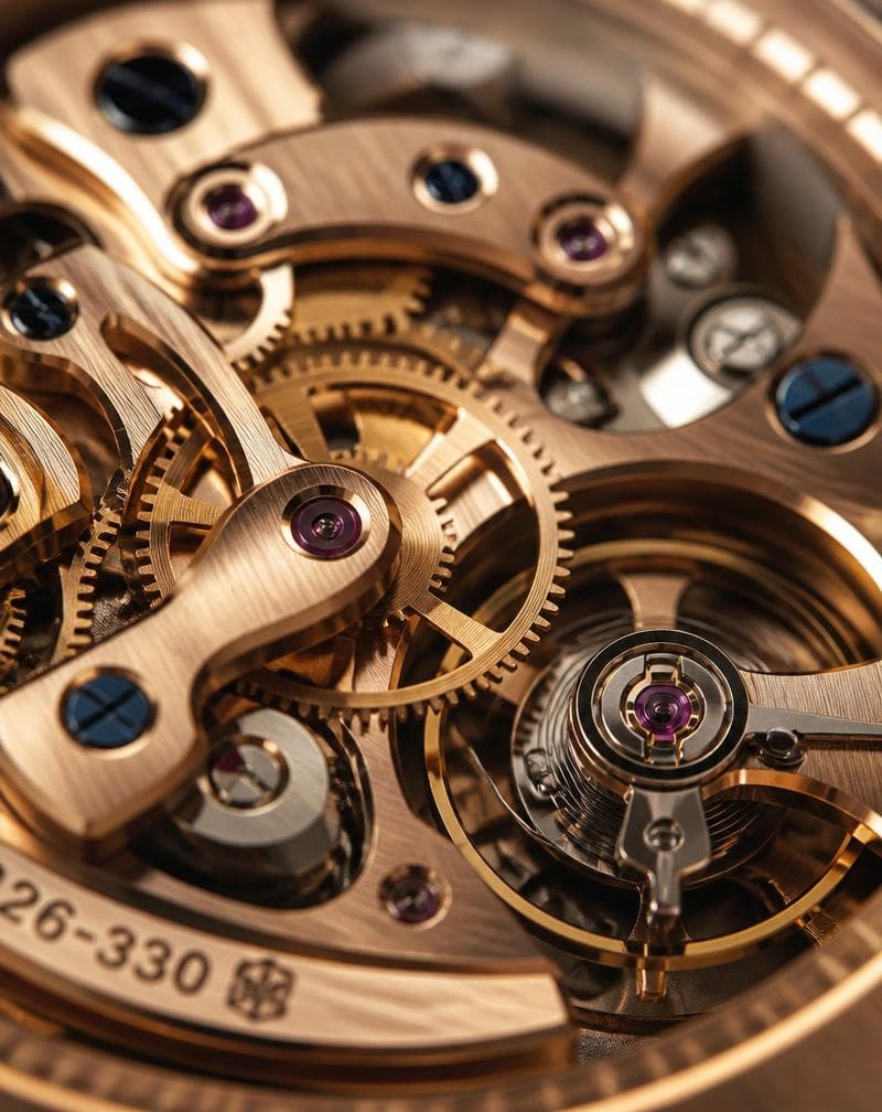 Macro of a mechanical watch movement in rose gold